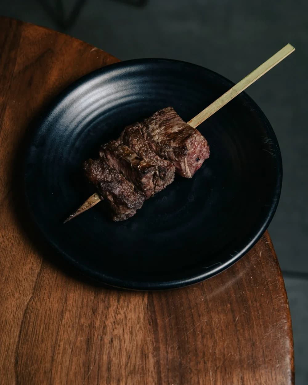 Small plates set out on a dark wood table, ready to share