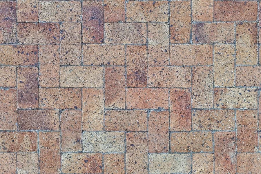 Close detail of herringbone clay paving stones after rain