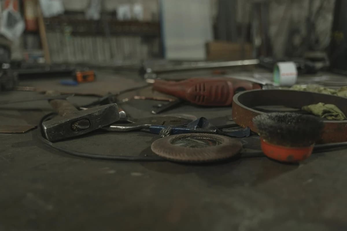 Roofer's tools and hard hat resting on corrugated metal roof sheeting